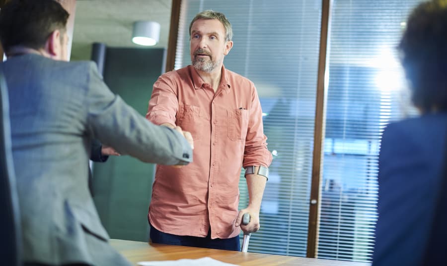 Injured man shaking hands with a personal injury lawyer