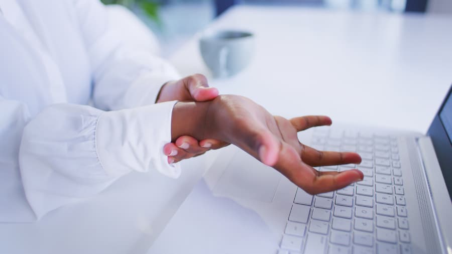 Close-up of a woman rubbing her wrist