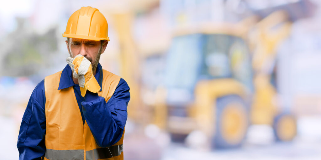 Construction worker coughing on job site